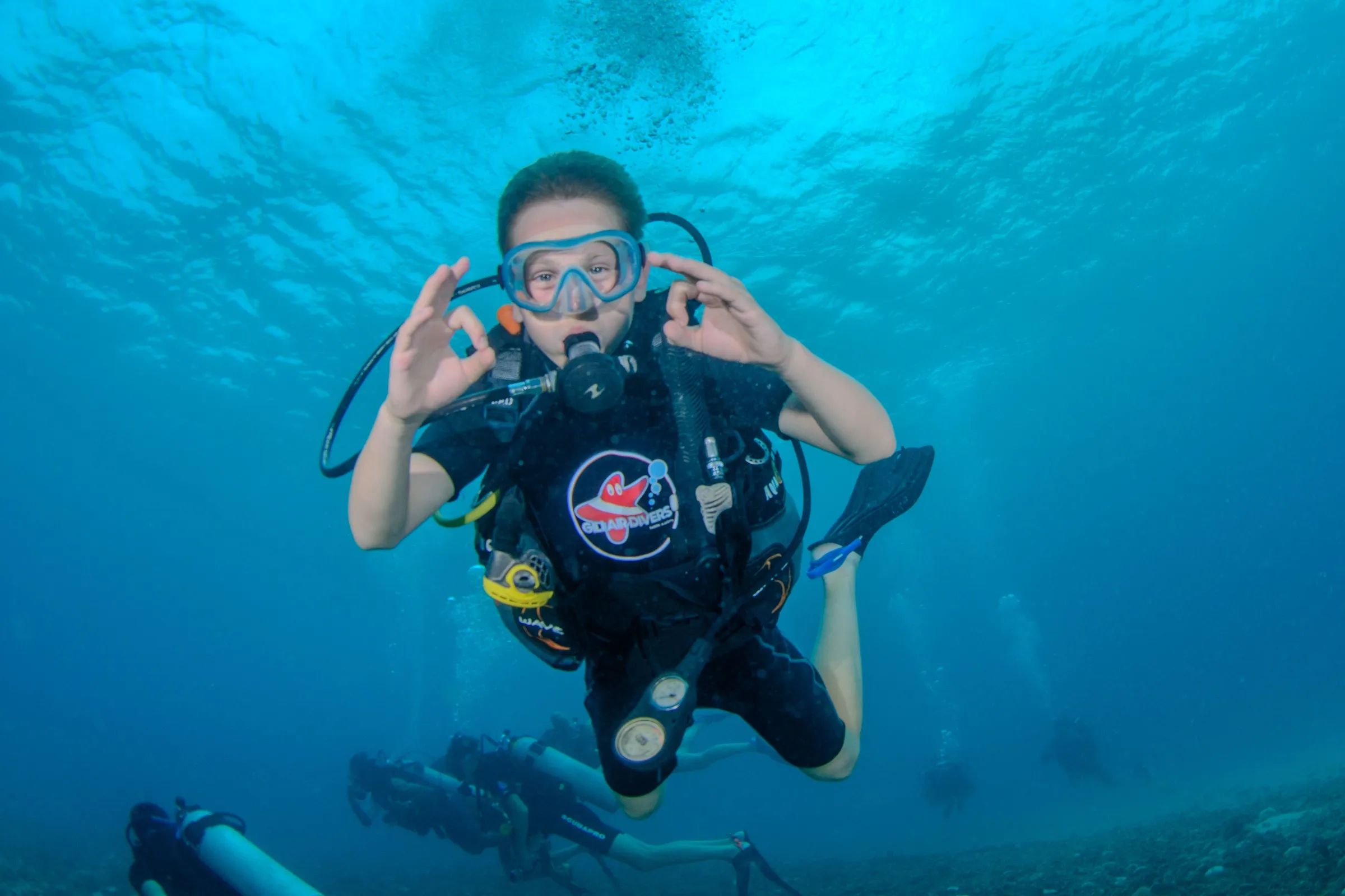Diver signaling rock-on at pool