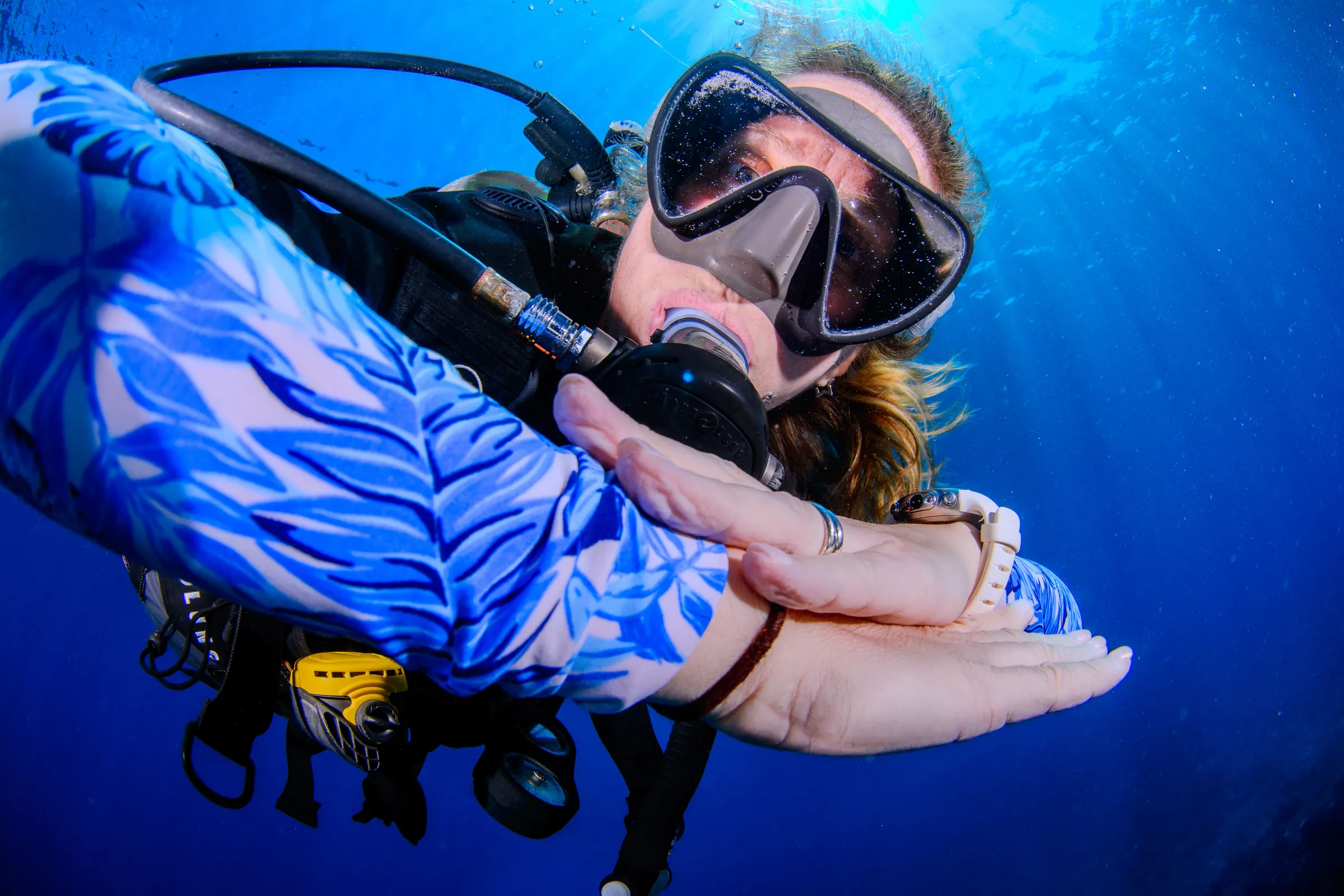 Diver making heart sign underwater