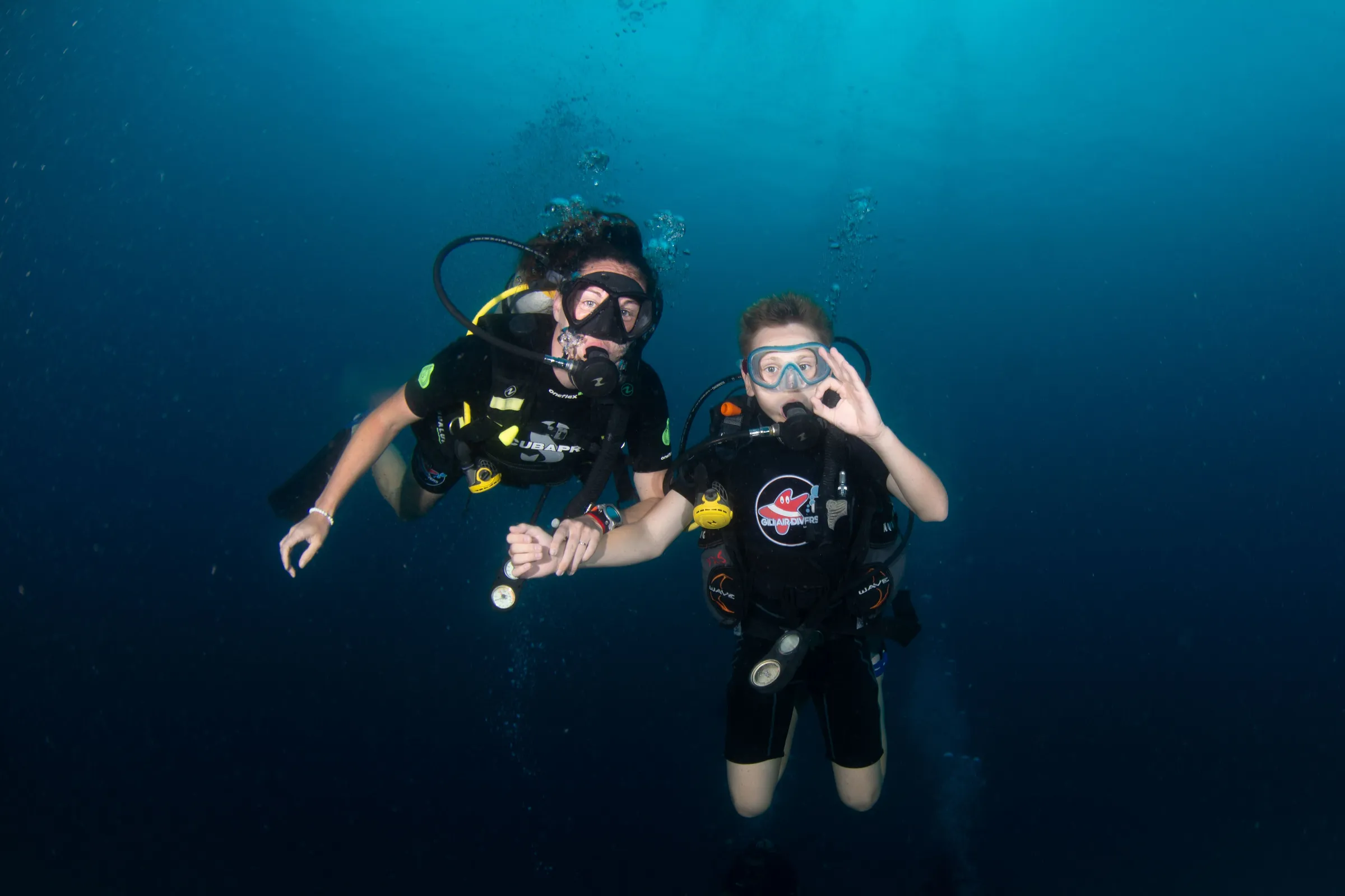 Buddy team posing in blue water