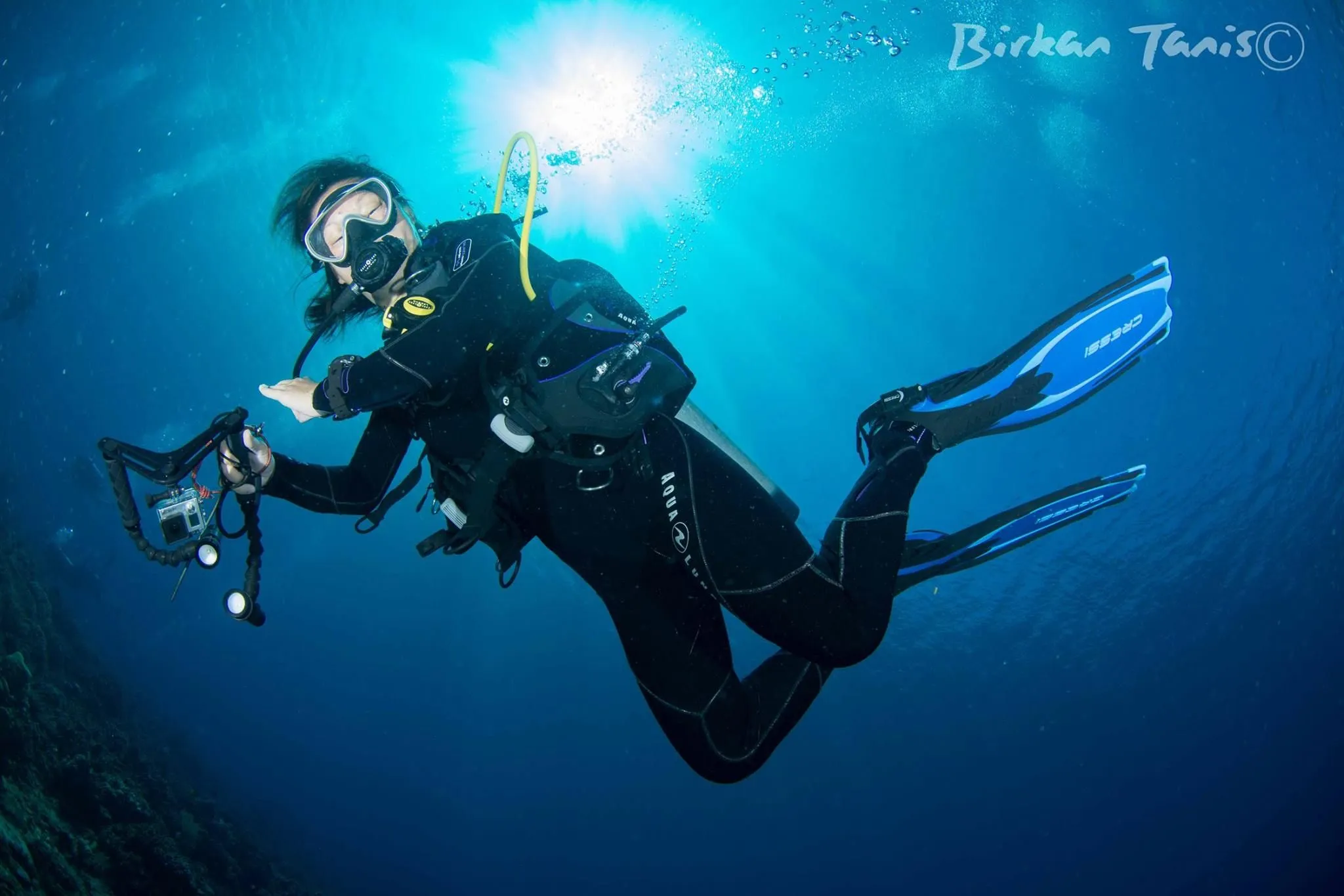 Diver shooting strobes underwater