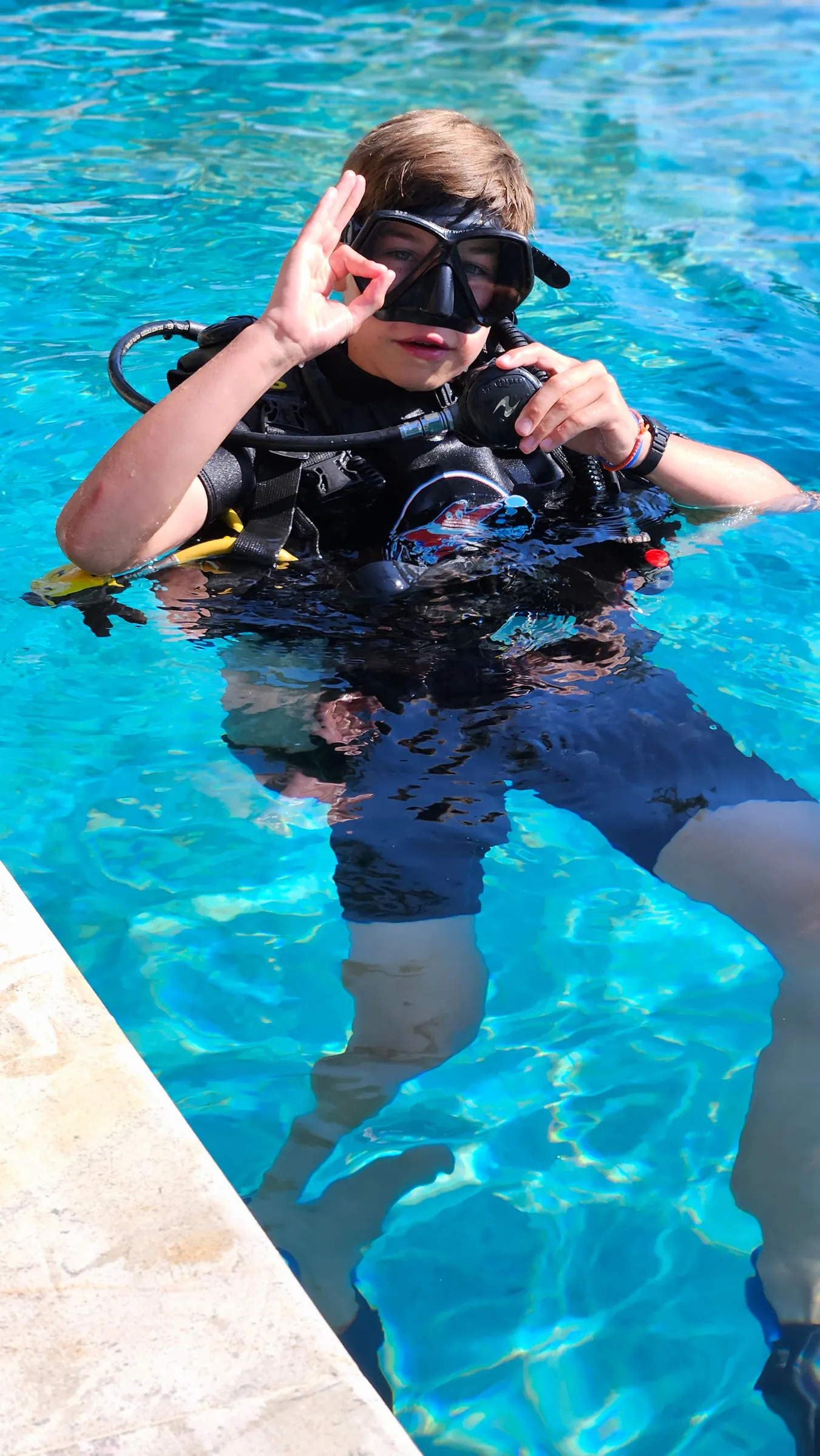 Diver demonstrating skills in pool