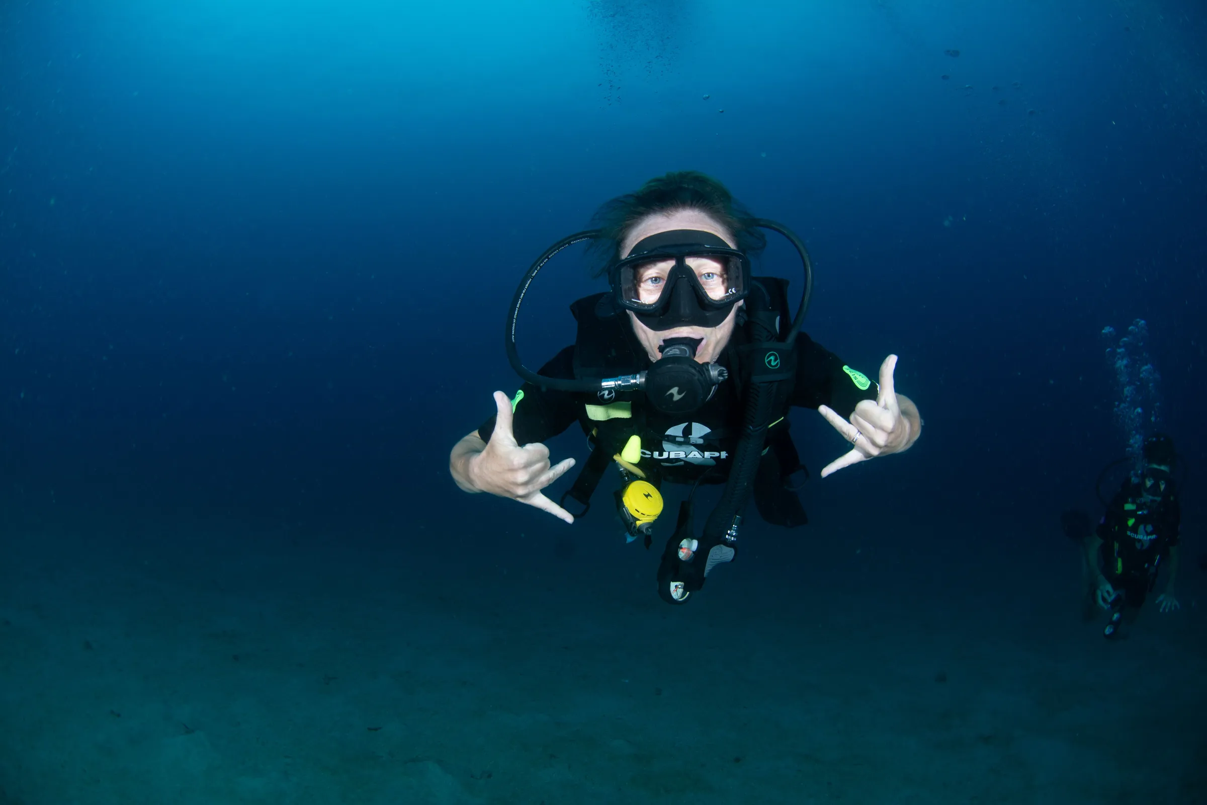 Diver flashing rock-on sign
