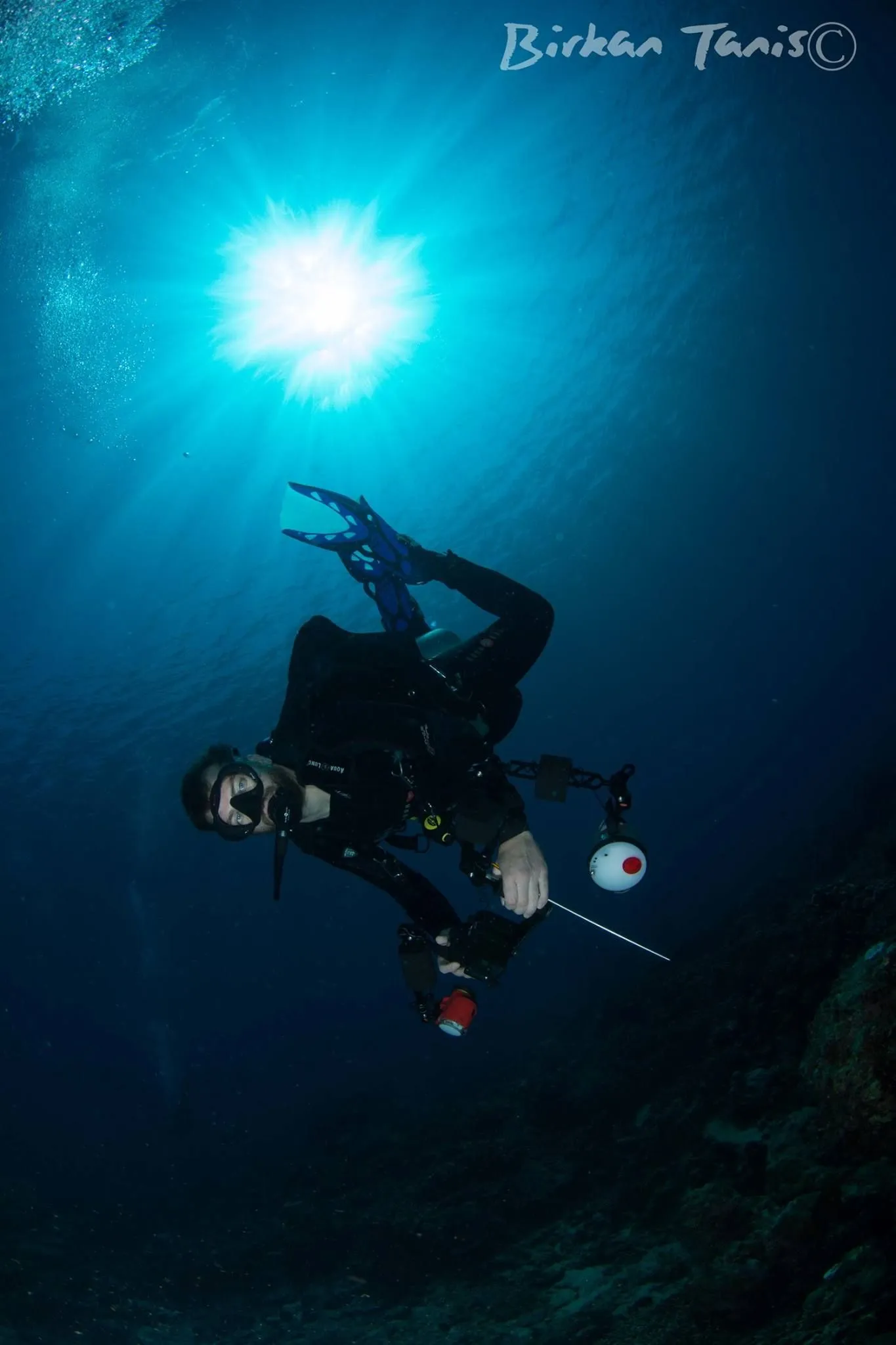 Diver framed by sunburst
