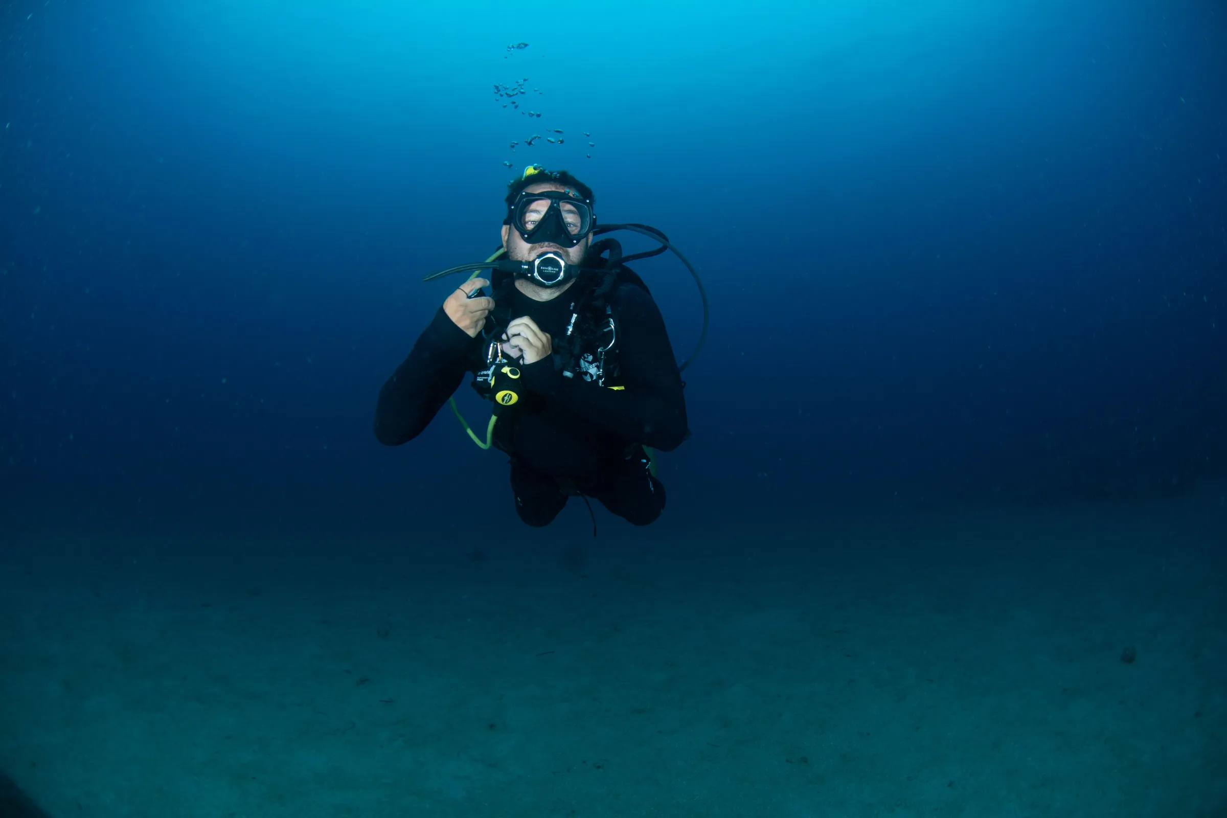 Diver hovering streamlined in blue